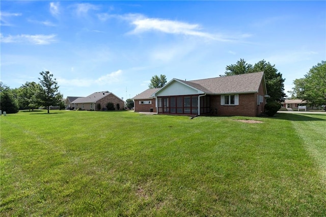 205 E 10th St, Carrollton, MO 64633 - view of green lawn featuring a sunroom