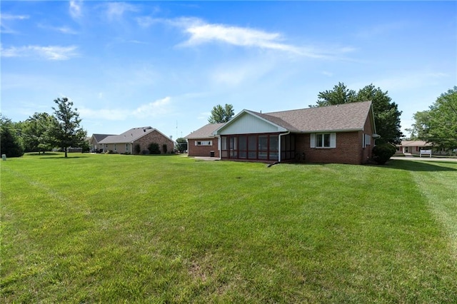205 E 10th St, Carrollton, MO 64633 - view of grassy yard featuring a sunroom