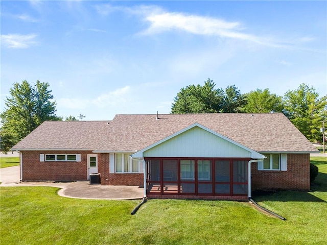 205 E 10th St, Carrollton, MO 64633 - rear view of property with a yard, roof with shingles, a patio area, and brick siding