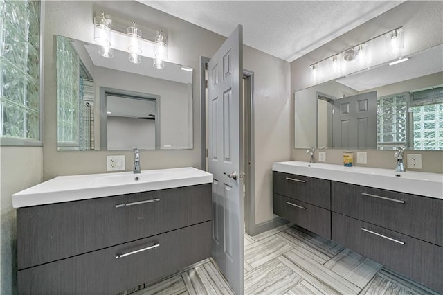 2517 Red Bridge Ter, Kansas City, MO 64131 - full bathroom with double vanity and a textured ceiling