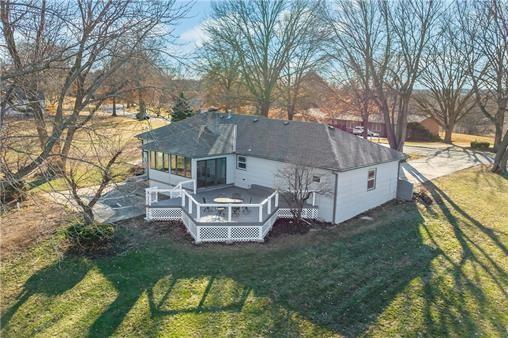 2517 Red Bridge Ter, Kansas City, MO 64131 - back of property featuring a sunroom, a wooden deck, and a yard