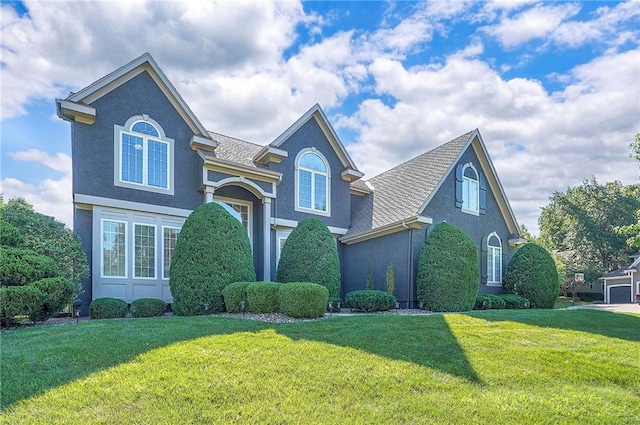 12337 Gillette St, Overland Park, KS 66213 - traditional home with a front yard, stucco siding, and roof with shingles