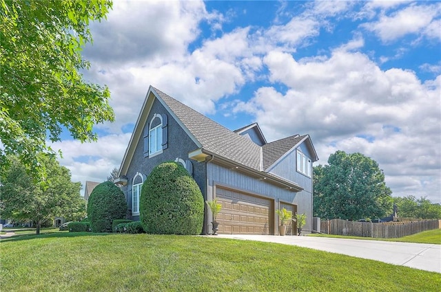12337 Gillette St, Overland Park, KS 66213 - view of side of home featuring driveway, roof with shingles, and an attached garage