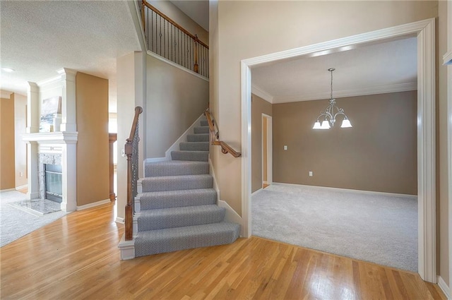 12337 Gillette St, Overland Park, KS 66213 - stairs with wood finished floors, crown molding, a chandelier, and carpet floors