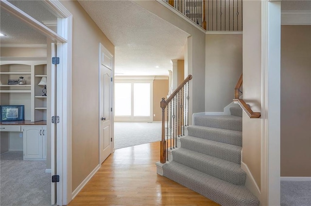 12337 Gillette St, Overland Park, KS 66213 - staircase featuring carpet, wood finished floors, and ornamental molding