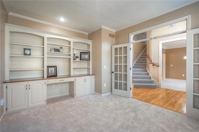 12337 Gillette St, Overland Park, KS 66213 - unfurnished office with light carpet, built in desk, ornamental molding, a textured ceiling, and french doors