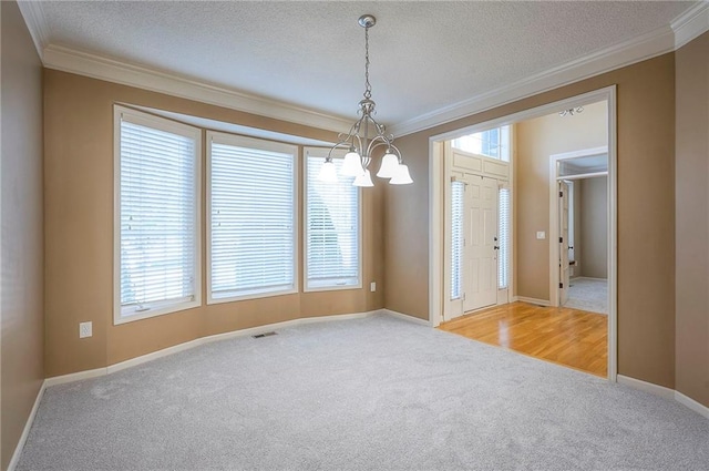 12337 Gillette St, Overland Park, KS 66213 - carpeted empty room with a chandelier, ornamental molding, healthy amount of natural light, and a textured ceiling