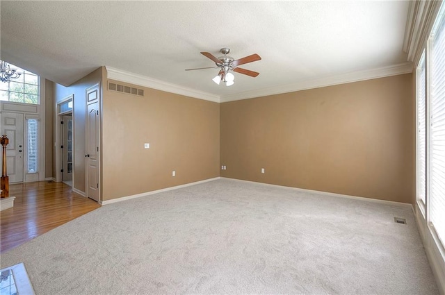 12337 Gillette St, Overland Park, KS 66213 - spare room with carpet floors, a ceiling fan, ornamental molding, a textured ceiling, and a chandelier