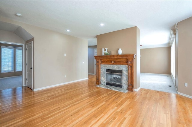 12337 Gillette St, Overland Park, KS 66213 - unfurnished living room featuring light wood-type flooring, a fireplace, and recessed lighting