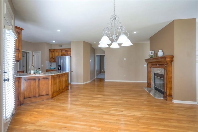 12337 Gillette St, Overland Park, KS 66213 - kitchen with stainless steel fridge with ice dispenser, brown cabinets, recessed lighting, light wood-style flooring, and plenty of natural light