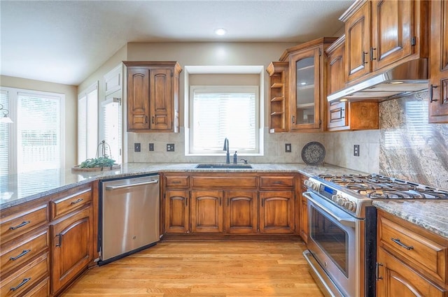 12337 Gillette St, Overland Park, KS 66213 - kitchen featuring stainless steel appliances, brown cabinetry, and light wood finished floors