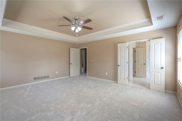 12337 Gillette St, Overland Park, KS 66213 - unfurnished bedroom featuring a raised ceiling, carpet flooring, a textured ceiling, crown molding, and ceiling fan