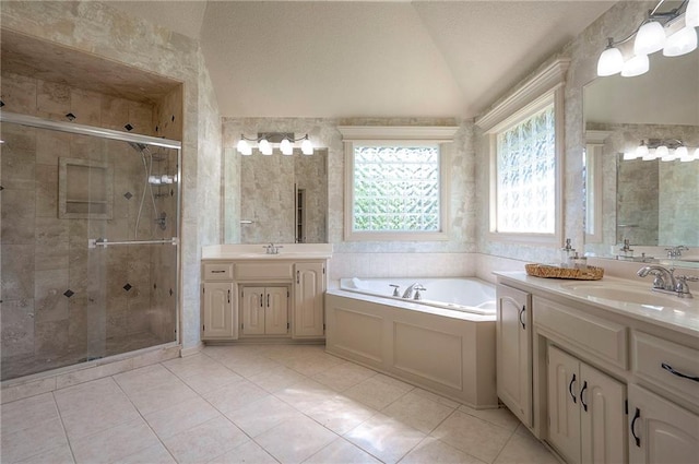 12337 Gillette St, Overland Park, KS 66213 - full bathroom featuring plenty of natural light, two vanities, a bath, a shower stall, and lofted ceiling