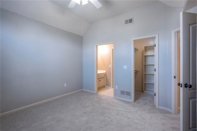 12337 Gillette St, Overland Park, KS 66213 - unfurnished bedroom featuring vaulted ceiling, a spacious closet, light colored carpet, ensuite bath, and ceiling fan
