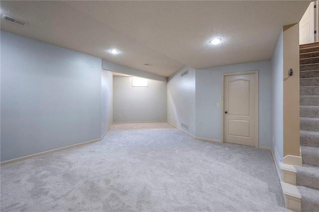 12337 Gillette St, Overland Park, KS 66213 - finished below grade area featuring stairway, light carpet, recessed lighting, and a textured ceiling