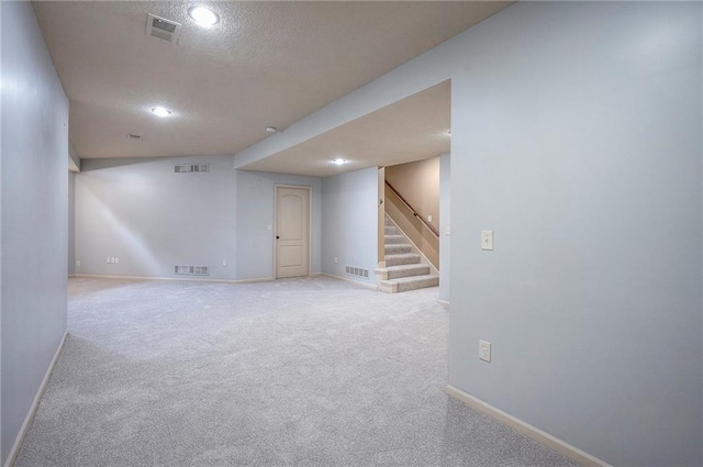 12337 Gillette St, Overland Park, KS 66213 - finished basement with stairway, carpet, a textured ceiling, and recessed lighting