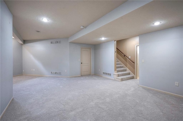 12337 Gillette St, Overland Park, KS 66213 - finished basement with a textured ceiling, recessed lighting, stairway, and carpet