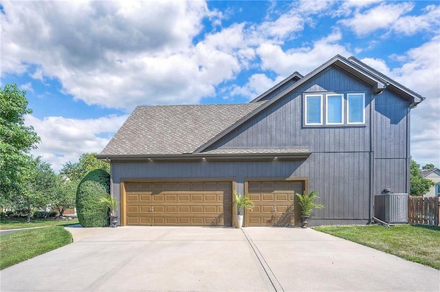 12337 Gillette St, Overland Park, KS 66213 - view of front of house featuring concrete driveway, roof with shingles, and a garage