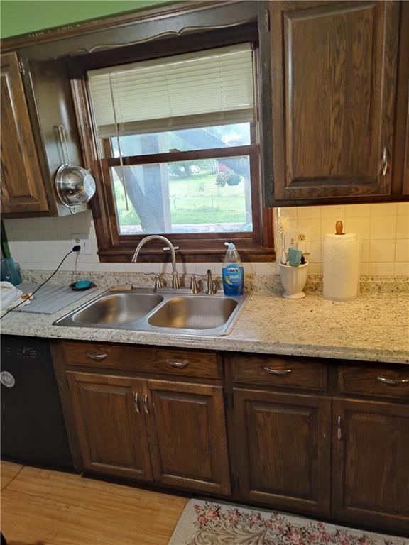 505 E Harold St, Olathe, KS 66061 - kitchen with healthy amount of natural light, backsplash, and dark brown cabinetry