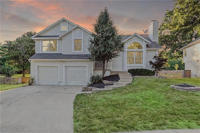 6236 W 156th St, Overland Park, KS 66223 - view of front of home with an attached garage, a chimney, concrete driveway, and a fire pit