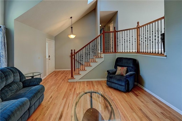 6236 W 156th St, Overland Park, KS 66223 - living area featuring wood finished floors, high vaulted ceiling, and stairway