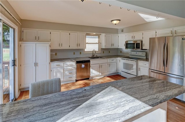 6236 W 156th St, Overland Park, KS 66223 - kitchen with stainless steel appliances, white cabinetry, light wood-style flooring, and light stone counters