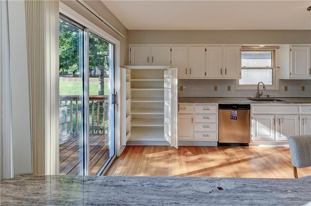 6236 W 156th St, Overland Park, KS 66223 - kitchen with stainless steel dishwasher, healthy amount of natural light, white cabinetry, and light wood finished floors