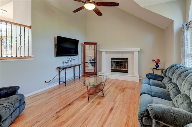 6236 W 156th St, Overland Park, KS 66223 - living area featuring a ceiling fan, healthy amount of natural light, wood finished floors, a fireplace, and high vaulted ceiling