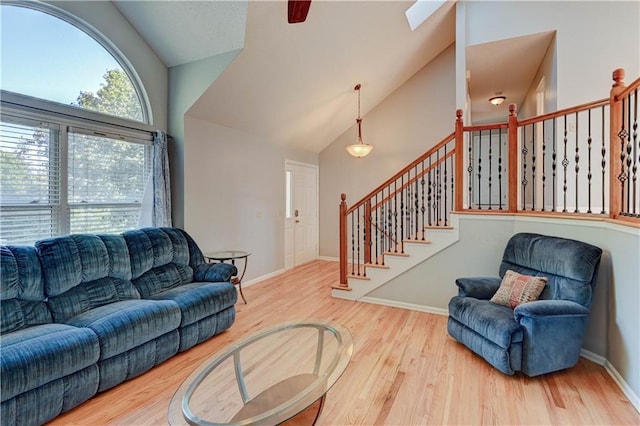 6236 W 156th St, Overland Park, KS 66223 - living room featuring wood finished floors, ceiling fan, stairway, and high vaulted ceiling