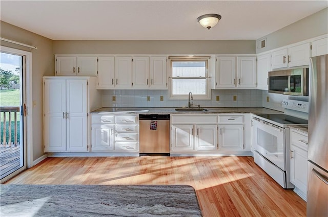 6236 W 156th St, Overland Park, KS 66223 - kitchen featuring stainless steel appliances, light wood-type flooring, white cabinetry, and decorative backsplash
