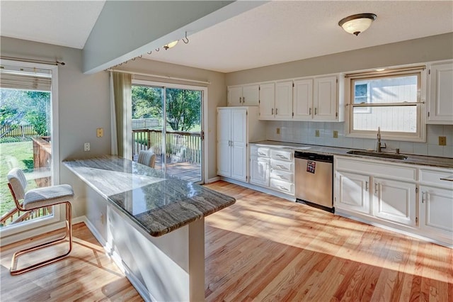 6236 W 156th St, Overland Park, KS 66223 - kitchen with dishwasher, white cabinetry, light wood-style flooring, plenty of natural light, and vaulted ceiling