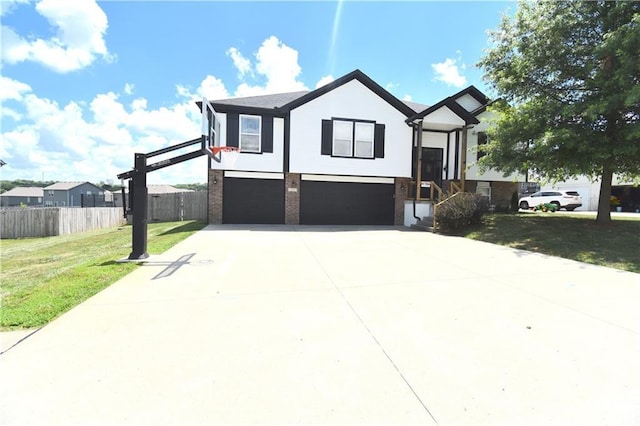 1207 SW 9th St, Oak Grove, MO 64075 - view of front of house with an attached garage, driveway, and brick siding