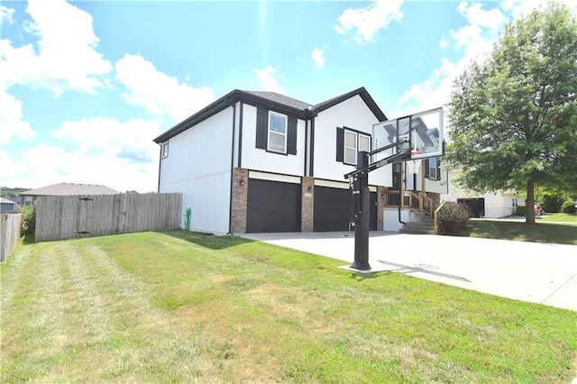 1207 SW 9th St, Oak Grove, MO 64075 - view of side of home with an attached garage, driveway, and brick siding