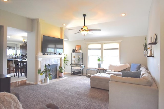 1207 SW 9th St, Oak Grove, MO 64075 - living area with ceiling fan, a tile fireplace, radiator, vaulted ceiling, and carpet floors