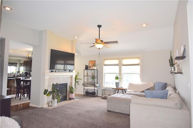 1207 SW 9th St, Oak Grove, MO 64075 - carpeted living area with a tile fireplace, a ceiling fan, recessed lighting, and vaulted ceiling