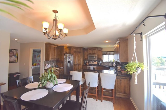 1207 SW 9th St, Oak Grove, MO 64075 - dining room with a chandelier, light wood-style flooring, and recessed lighting