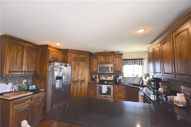 1207 SW 9th St, Oak Grove, MO 64075 - kitchen with stainless steel appliances, dark countertops, tasteful backsplash, a peninsula, and recessed lighting