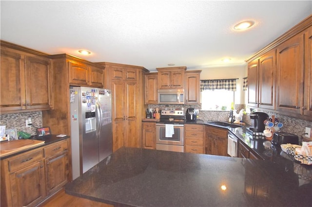 1207 SW 9th St, Oak Grove, MO 64075 - kitchen featuring stainless steel appliances, dark countertops, decorative backsplash, and recessed lighting