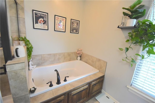 1207 SW 9th St, Oak Grove, MO 64075 - bathroom featuring a whirlpool tub and baseboards