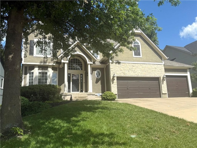 4531 Anderson St, Shawnee, KS 66226 - view of front of property with a front lawn, concrete driveway, stucco siding, stone siding, and an attached garage