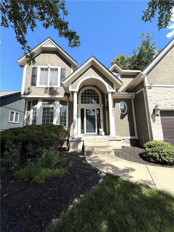 4531 Anderson St, Shawnee, KS 66226 - view of front of house featuring stucco siding and a garage