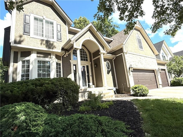 4531 Anderson St, Shawnee, KS 66226 - view of front of home with an attached garage, concrete driveway, stucco siding, and stone siding