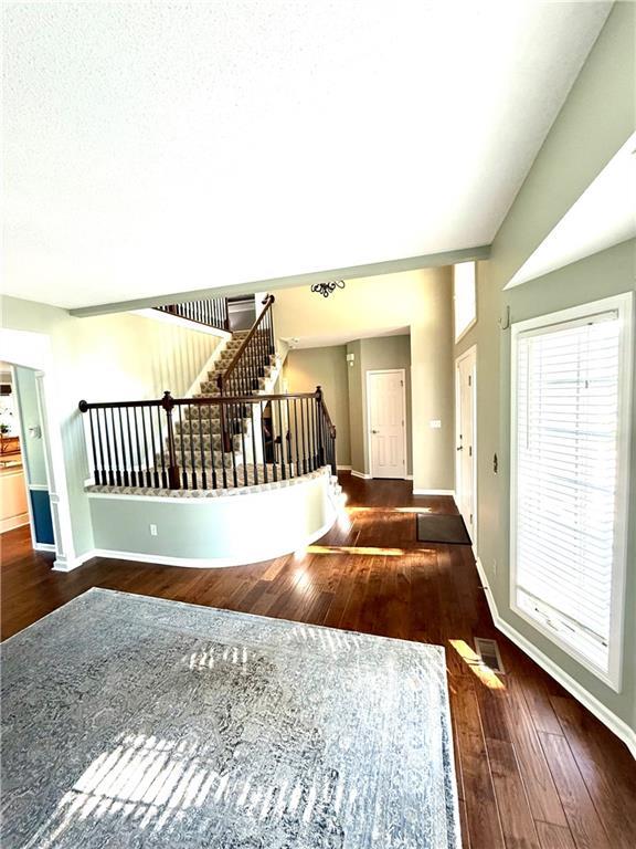 4531 Anderson St, Shawnee, KS 66226 - entrance foyer featuring stairs and hardwood / wood-style flooring
