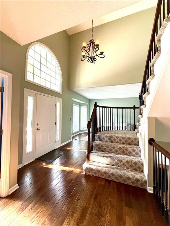 4531 Anderson St, Shawnee, KS 66226 - foyer featuring a high ceiling, hardwood / wood-style floors, stairs, and a chandelier