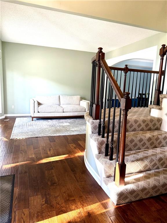 4531 Anderson St, Shawnee, KS 66226 - staircase with hardwood / wood-style flooring and arched walkways
