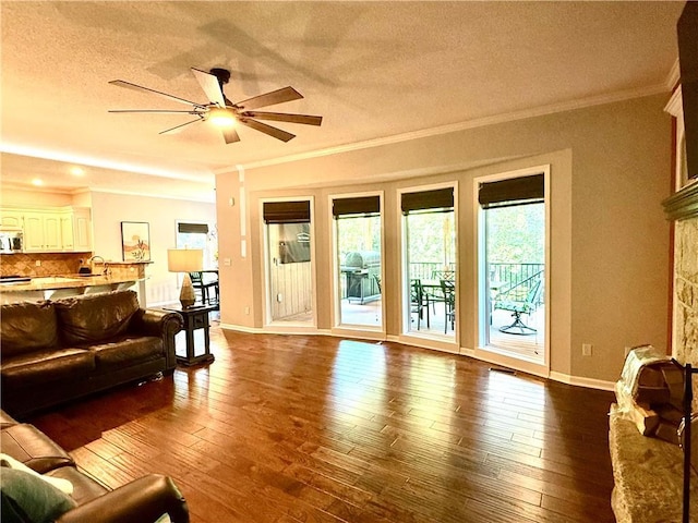 4531 Anderson St, Shawnee, KS 66226 - living room with ornamental molding, a ceiling fan, dark wood finished floors, and a textured ceiling