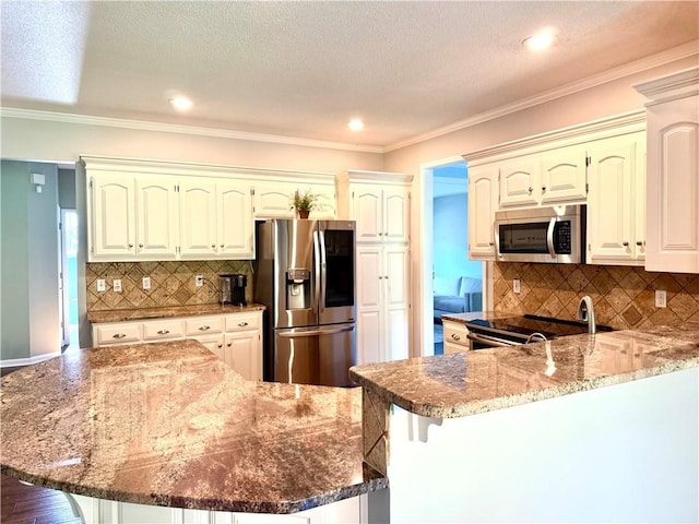 4531 Anderson St, Shawnee, KS 66226 - kitchen featuring stainless steel appliances, a peninsula, dark stone counters, tasteful backsplash, and a breakfast bar