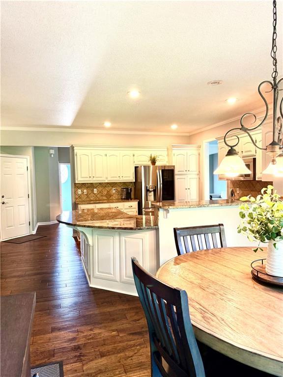 4531 Anderson St, Shawnee, KS 66226 - dining area featuring dark wood-style floors, recessed lighting, and ornamental molding