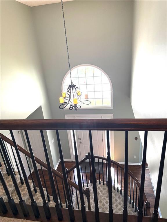 4531 Anderson St, Shawnee, KS 66226 - stairs featuring a chandelier and a high ceiling