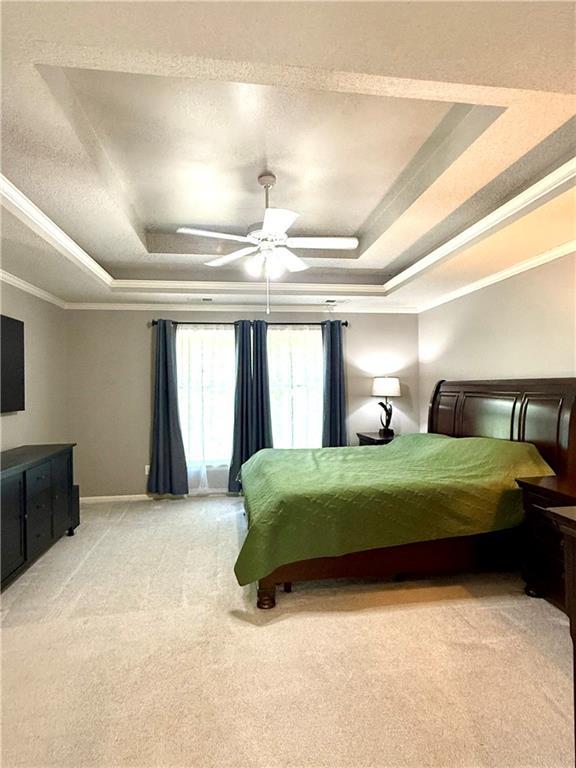 4531 Anderson St, Shawnee, KS 66226 - bedroom with a tray ceiling, light carpet, crown molding, and ceiling fan